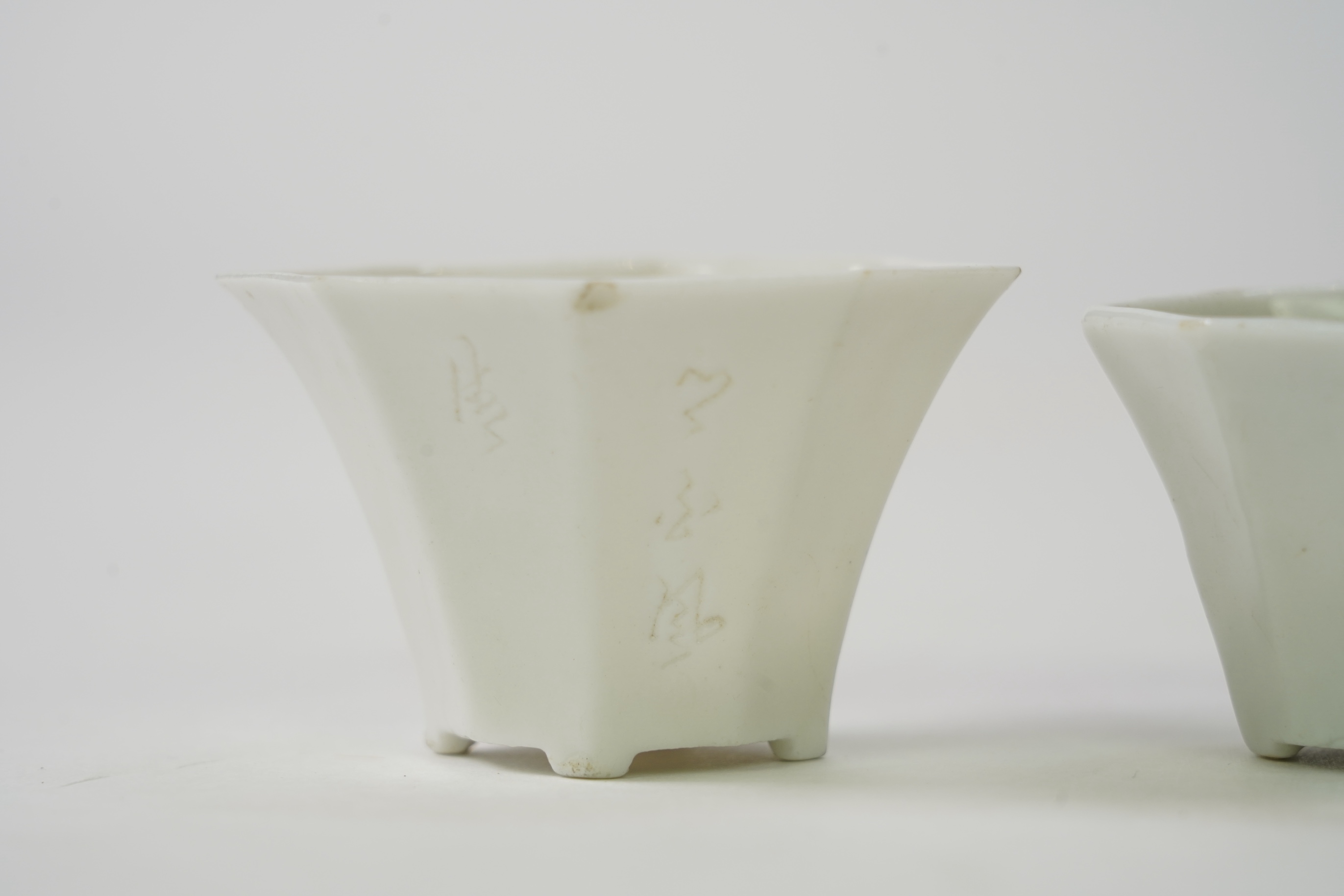 Two Chinese Dehua blanc de chine octagonal cups, Kangxi period